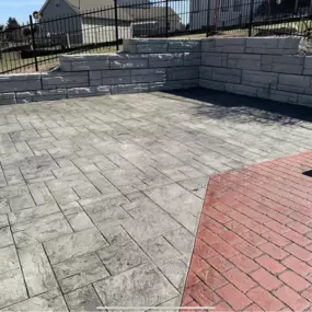 Decorative concrete patio with retaining wall