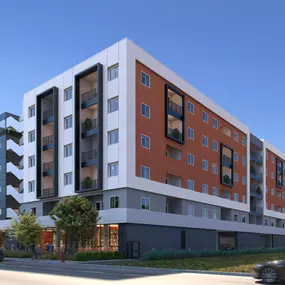 A red, white, and grey building with 6 stories and a blue sky