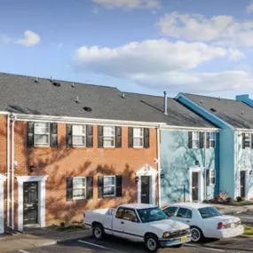 The front exterior of Hilton Village Townhomes showcases charming architecture with convenient parking