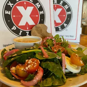 Spinach, crisped smoked bacon, hard boiled egg, choice of feta, goat, or Gorgonzola cheese, pickled red onions, halved mini tomatoes, and toasted sliced almonds.
