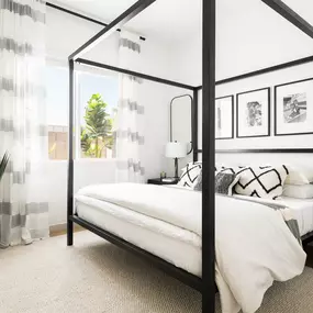 a bedroom with a bed and a black canopy bed