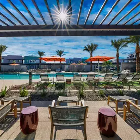 an outdoor patio with tables and chairs and a pool