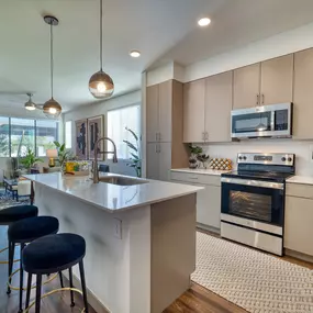 an open kitchen with an island and stools
