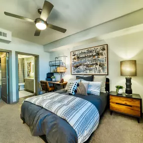 a bedroom with a bed and a ceiling fan