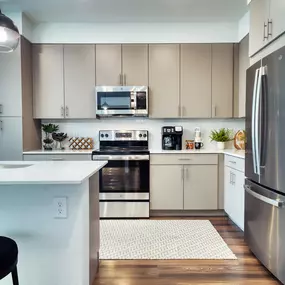 a kitchen with stainless steel appliances and white cabinets