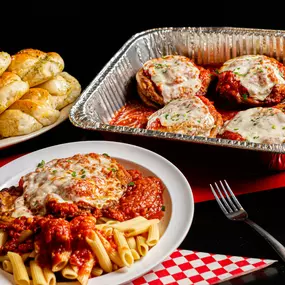 Eggplant parmesan with penne pasta and garlic knots from Bambinelli’s Pizza & Pasta—one of the best Italian restaurants in Atlanta. A perfect pick for pasta in Atlanta or for those searching Italian restaurants Atlanta.