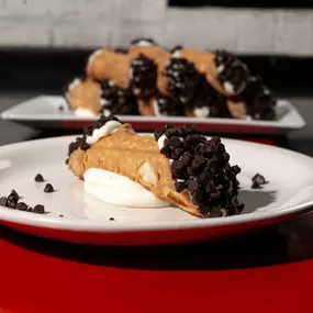 Fresh cannoli from Bambinelli’s Pizza & Pasta—an Italian restaurant in Atlanta serving up classic desserts to pair with your favorite pasta or pizza in Atlanta. A perfect finish for anyone searching Italian restaurants Atlanta.