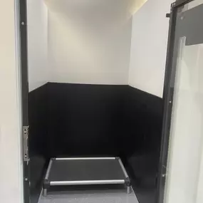 A clean, spacious individual dog suite at Playtime Pet Resort Exeter features a raised cot and easy-to-sanitize walls and flooring, ensuring comfort and hygiene during every stay.