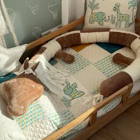 Canenya - Raumdesign für Kinder Liebevoll gestaltete Bettschlange in Pferdeform in warmen Brauntönen, kombiniert mit passender Kinderbettwäsche und Elefantenkissen – ideal für Kinderzimmer in Hamburg-Stellingen.