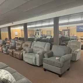 Wide variety of recliners and armchairs on display in different colors and materials.