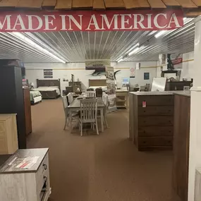 Furniture gallery highlighting American-made dining and bedroom sets under a red “Made in America” banner.