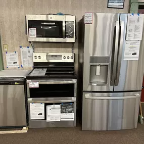 Full GE kitchen package on display, including a refrigerator, range, microwave, and dishwasher—perfect for customers planning a full kitchen upgrade.