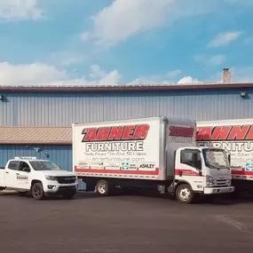 Ahner's delivery trucks and branded pickup truck parked outside the storefront—highlighting their large-scale delivery and customer service operation.