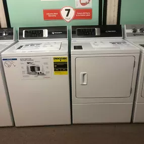 Speed Queen washer and dryer set with extended 7-year warranty signage above—known for durability and American-made quality.