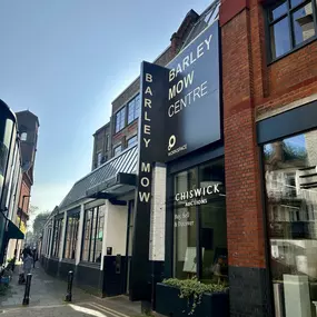 A broader view of the Barley Mow Centre on a clear day, showing red brick architecture and multiple floors, with the AECOR office located at 10 Barley Mow Passage, London.