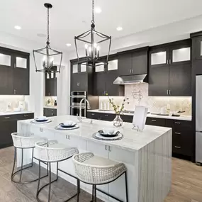 Gorgeous kitchens with large center islands, brand-name stainless steel appliances, and granite countertops