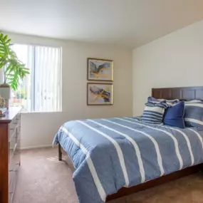A cozy bedroom at Midtown at Seneca Apartments featuring soft carpeting and ample natural light.