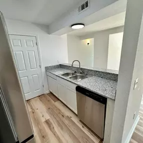 a kitchen with a sink and a dishwasher