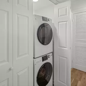 A white washing machine and dryer in a laundry room.