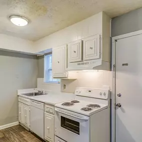 A kitchen with white appliances and cabinets.