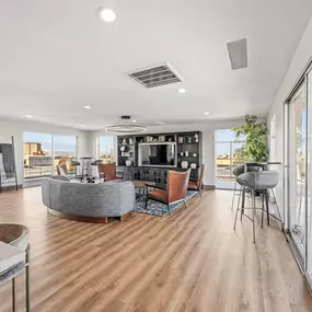 A modern living room with a curved sofa and a television