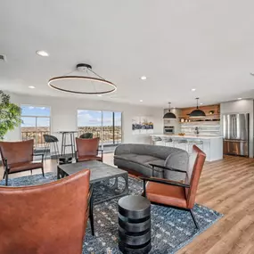 A modern living room with brown leather chairs and a wooden floor