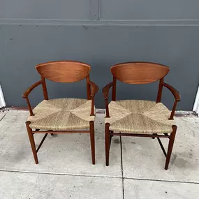 Two Danish Teak Model No. 317 armchairs with woven paper cord armrests, designed by Peter Hvidt & Orla Molgaard-Nielsen, are displayed.