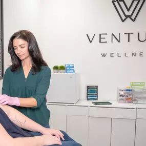 Venture Wellness provider administering a patient injection in a modern Midlothian, Virginia clinic. The clean, welcoming environment highlights the practice’s focus on safe, professional care, hormone optimization, peptide therapy, and medical weight loss treatments.