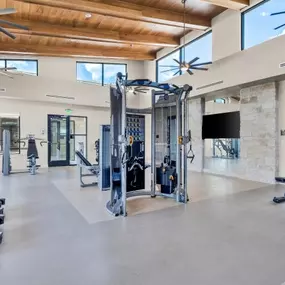 Fully equipped fitness center with cardio and strength training machines at Pyland Ranch