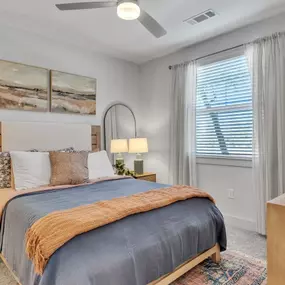 Spacious bedroom with large windows and modern finishes at Pyland Ranch Apartments