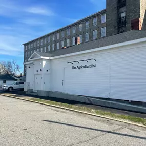 Street view of The Agriculturalist Dispensaryeaturing a modern white exterior.