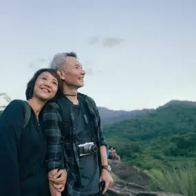 Healthy senior couple hiking scenic trail—results of The Maxim Clinic wellness care