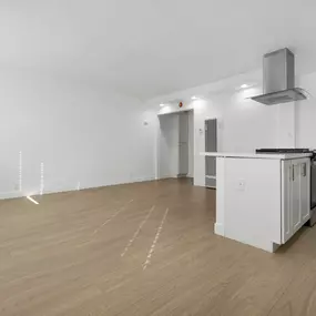 A kitchen area with a white cabinet and a stove top oven.