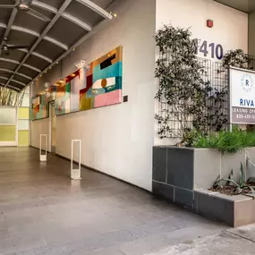 Entrance to the Riva Apartments in Santa Monica, CA, featuring modern design elements that reflect the community's upscale and inviting atmosphere.