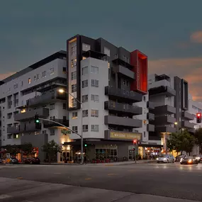 Exterior view of Harlow luxury apartments in Culver City, showcasing modern architecture with clean lines, large windows, and vibrant design elements.