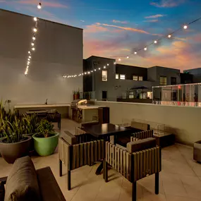 Rooftop terrace at Harlow luxury apartments in Culver City, featuring comfortable seating and panoramic views of the city skyline.