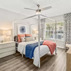 Master bedroom with ceiling fan, nightstands, and a dresser