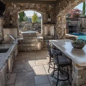 Outdoor kitchen design with limestone, slate and stucco