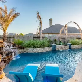 New pool construction, pool rock waterfall, retaining wall, columns, ledge loungers on Baja shelf