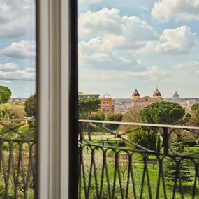 View over lush gardens and St. Peter's  Dome from a balcony at Hotel Eden Rome