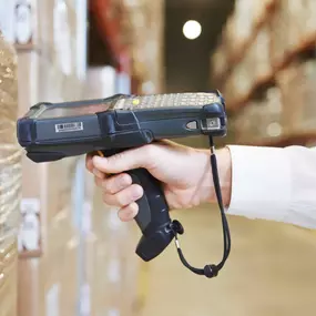 Barcode Scanner with Warehousing Tag Label Example on Wrapped Shipping Pallet