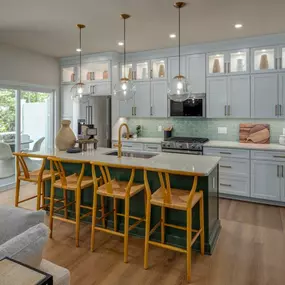 Well-appointed kitchens with large center islands and walk-in pantries
