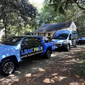 leak pros of georgia truck and van outside of a house