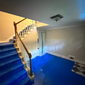 basement with blue tarp laid down