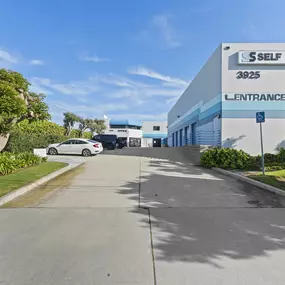 Spencer Street Self Storage facility exterior front view showing blue and white building design with drive-up units and clear entrance signage at 3925 Spencer Street.