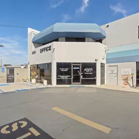 Spencer Street Self Storage office entrance featuring distinctive blue awning, accessible parking, and professional storefront at 3925 Spencer Street. Clearly marked 