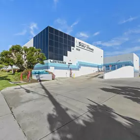 Spencer Street Self Storage exterior view showcasing modern architectural design with distinctive glass facade and blue accent details at 3925 Spencer Street. The professional building exterior features clean lines and excellent visibility from the street and sidewalk.
