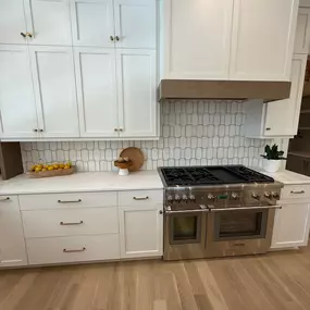 Fully remodeled kitchen with new cabinets, backsplash, and integrated oven and stove system.