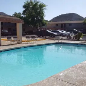 A small pool with a concrete floor and a concrete wall.