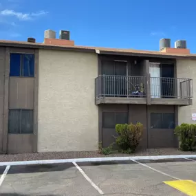 A building with a parking lot in front of it.